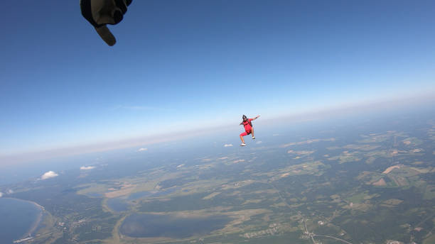 istock Skydiver falls through clear skies, in aerial flight 1176308706