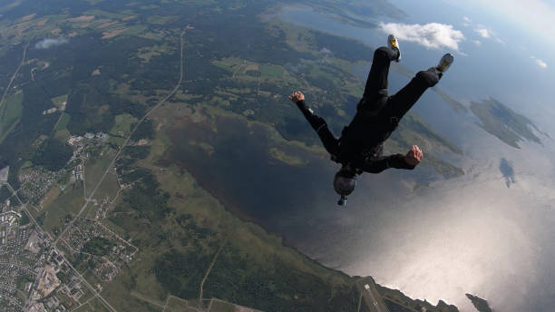 istock Skydivers fall through clear skies, in aerial flight 1176308789