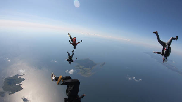 istock Skydivers fall through clear skies, in aerial flight 1176308826