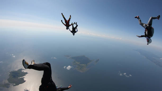 istock Skydivers fall through clear skies, in aerial flight 1176308866