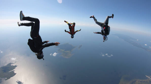 istock Skydivers fall through clear skies, in aerial flight 1176308918