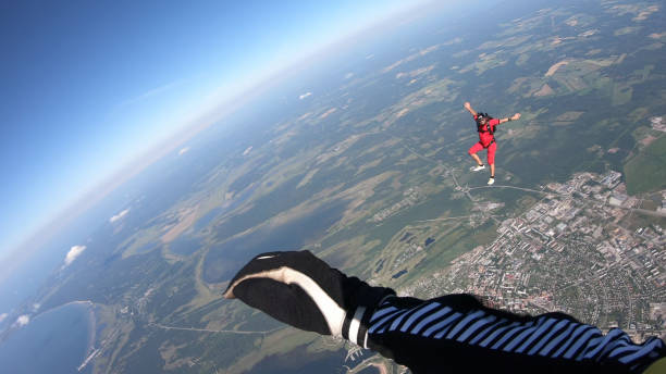 istock Skydiver falls through clear skies, in aerial flight 1176308957
