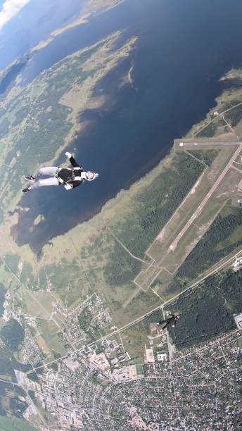 istock Skydivers fall through clear skies, in aerial flight 1176308989
