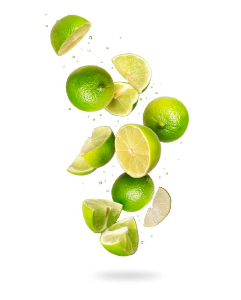 istock Whole and sliced fresh lime in the air, isolated on a white background 1176311384
