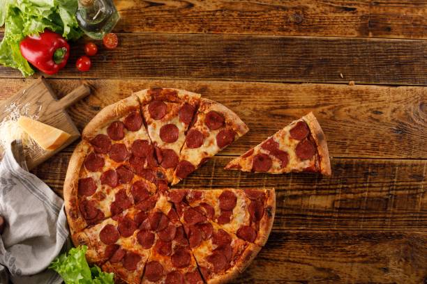 istock Pepperoni pizza on a wooden table. Still life with ingredients. Top view. Copy space. 1176311496