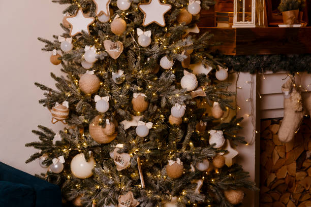 istock beautiful elegant Christmas tree decorated with white and gold balls with bows 1176311794