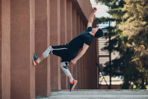 istock Parkour young man making acrobatic trick and flip jumping high 1176312827