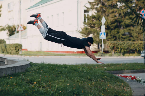 istock Parkour young man making acrobatic trick and flip jumping high 1176312841