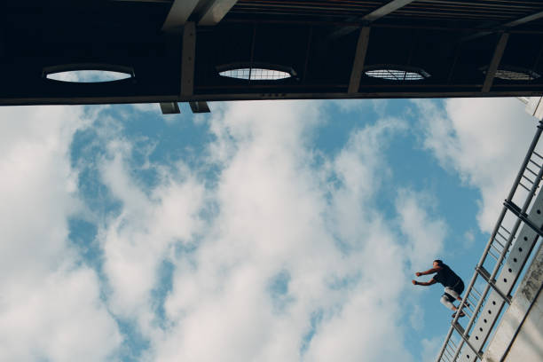 istock Parkour young man making acrobatic trick and flip jumping high 1176312842