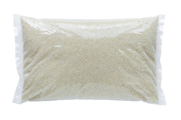 Rice packed in a plastic bag Rice packed in a plastic bag on a white background rice sack stock pictures, royalty-free photos & images
