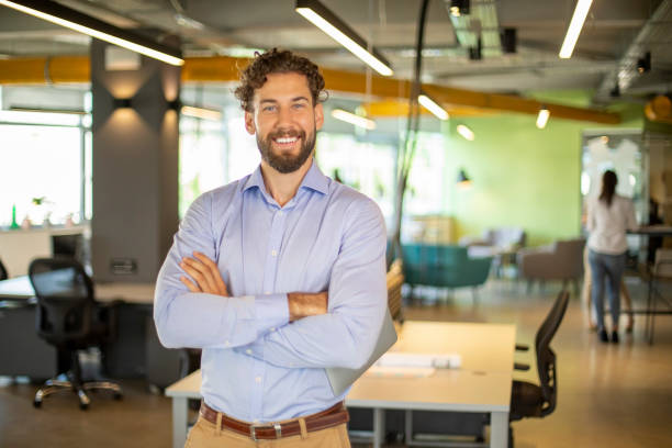 istock Smiling businessman at office. 1176314524