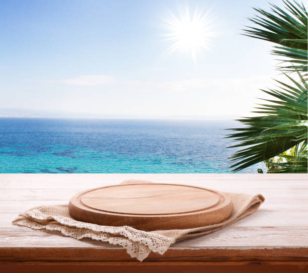 Pizza board, with tablecloth on wooden table and summer background. Top view mockup