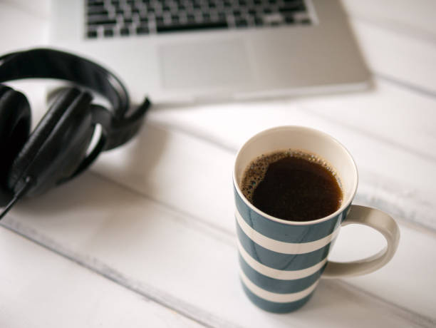 istock White wooden working desk with notebook and large mug of coffee 1176315882
