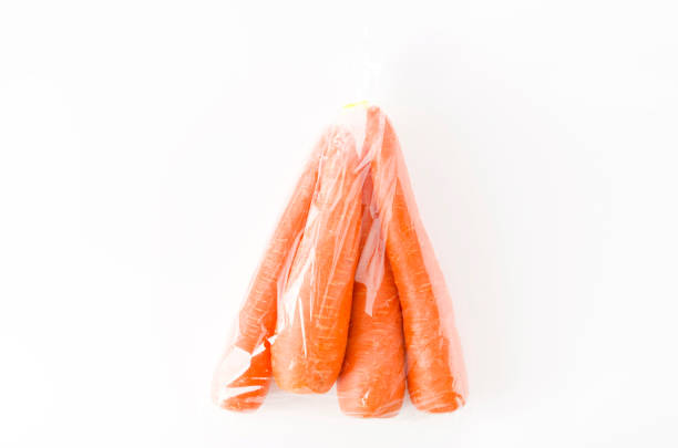 fresh Carrot in plastic bag on white background