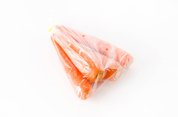 istock fresh Carrot in plastic bag on white background 1176320130