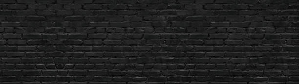 istock Black brick wall texture. Gloomy grunge panoramic dark background 1176324335