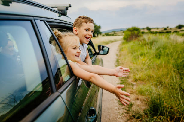 On the road trip Photo of smiling brother and sister on the road trip field trip stock pictures, royalty-free photos & images