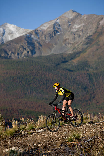 istock Young Woman Riding Bicycle In The Mountains 117632639