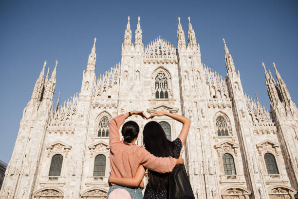 istock happy girlfriends look at the duomo 1176329563