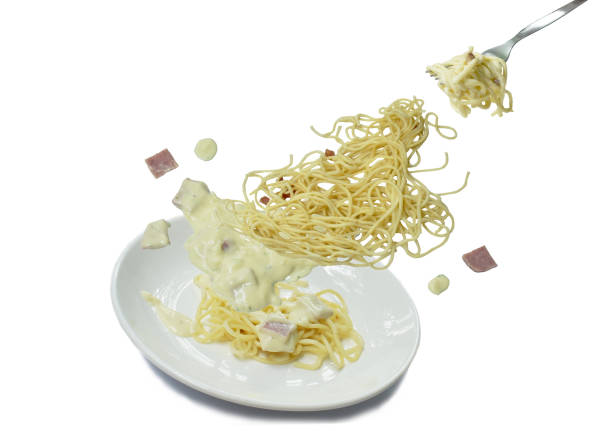 istock spaghetti white cream sauce topping slice ham pork rolled in fork floating 1176330016
