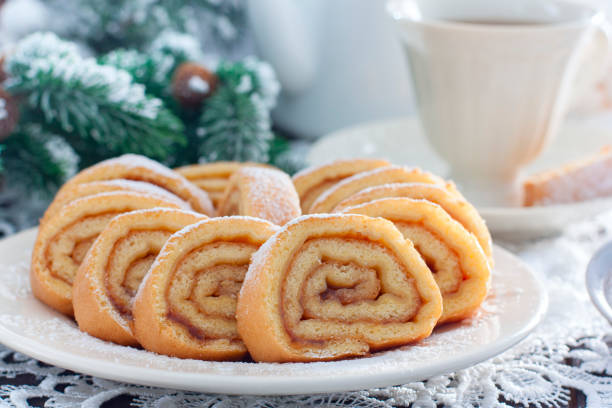 Biscuit festive roll with apple jam on a white bowl, horizontal