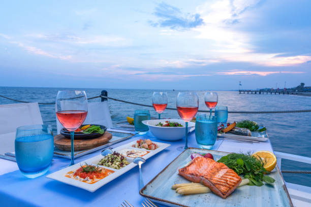 Seafood and appetizers. Various seafood dinner table ready at seaside with appetizers and drinks at afternoon