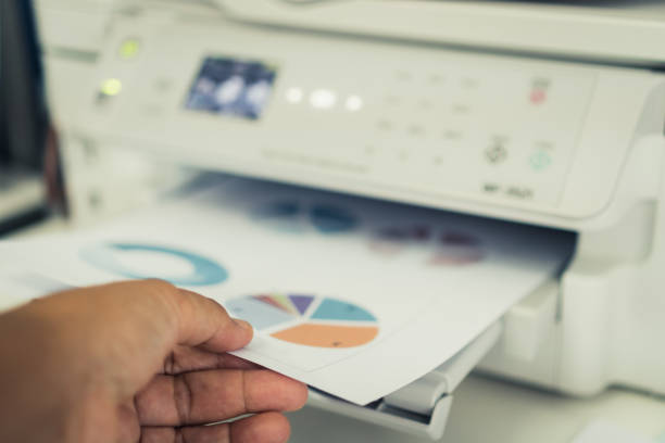 istock Business printer / printing documents in office concept:Businessman press document graph for report finacial in laser printed cartridge feeder, scanner machine for copy chart in busy offices 1176339307
