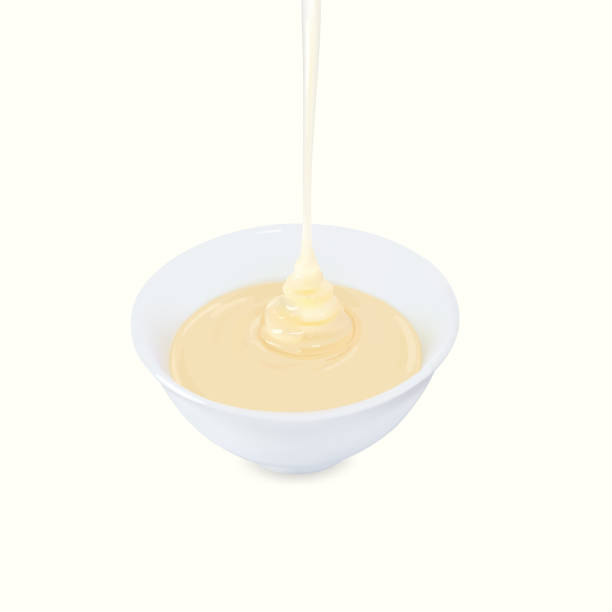 istock Pouring condensed milk with sugar in a bowl. 1176339649