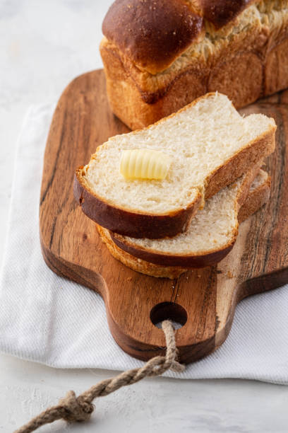 istock Delicious homemade organic fresh brioche bread on white table. 1176339925