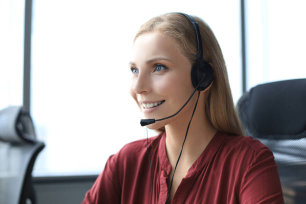 istock Beautiful smiling call center worker in headphones is working at modern office 1176340029
