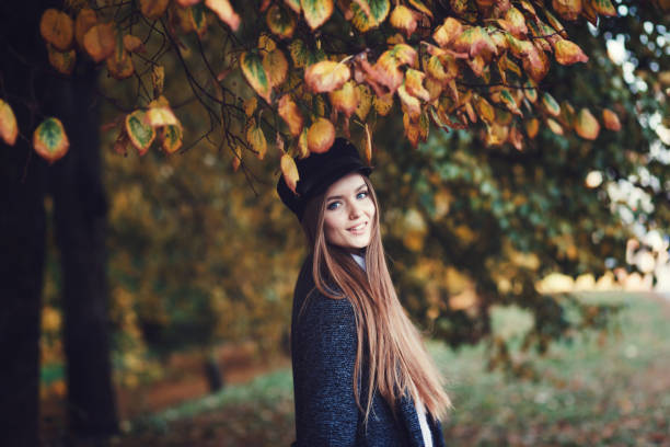 istock stylish woman in autumn park 1176342308