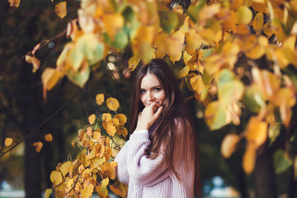 istock woman in autumn park 1176342334