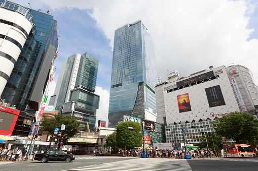 Tokyo, Japan - August 14, 2019 : People at Shibuya District, Tokyo, Japan. It is a famous shopping district in Tokyo. Many department stores, boutiques, shoe stores, accessory shops, restaurants, and game centers are located in this district. The new landmark in Shibuya - the 230-meter tall Shibuya Scramble Square will open on November, 2019.