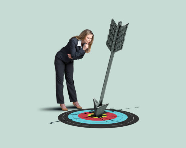 istock Woman Looking At Arrow Hitting Bull's Eye 1176349775