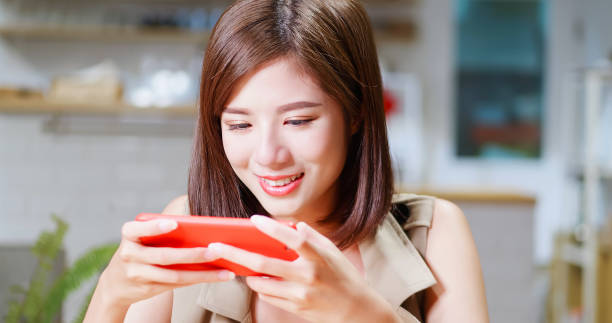 istock Young woman play mobile game 1176349929