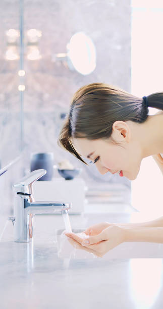istock beauty woman wash her face 1176350236