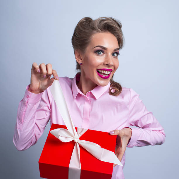 istock Funny woman unpacks gift 1176352785