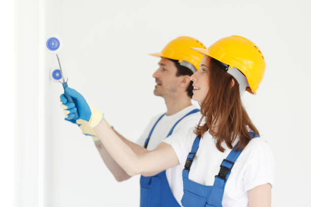 istock Workers painting walls in new house 1176352818