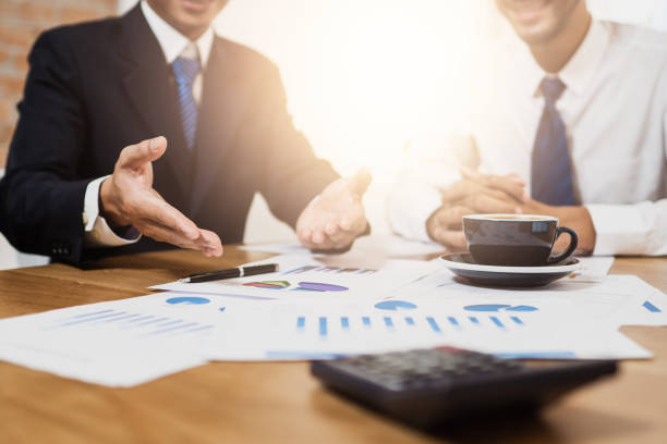 istock Administrator business man financial inspector planning with accountant secretary making report, discussing the charts and graphs showing the results of their successful teamwork. 1176354611