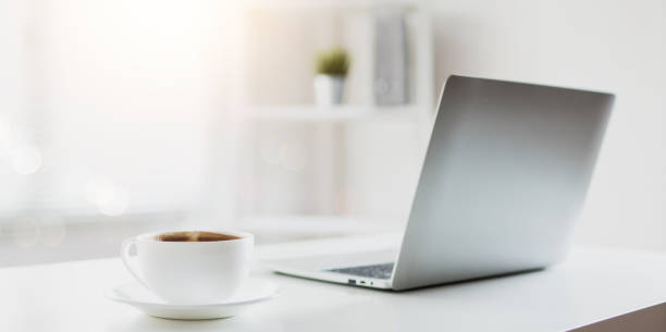 istock cup of coffee on working table with laptop 1176356742