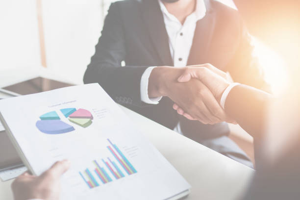 istock Successful financial business, businessman holding graph reports and shake hands with lead generator manager, teamwork of accountants in office 1176356750