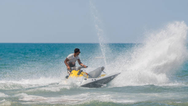 istock Young men cruising sea on a jet ski 1176358470