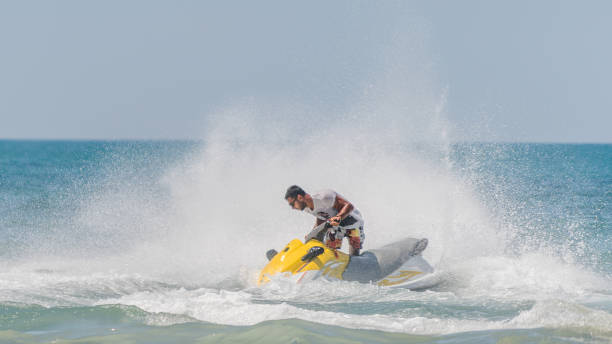 istock Young men cruising sea on a jet ski 1176358537