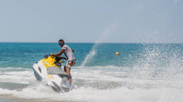 istock Young men cruising sea on a jet ski 1176358610