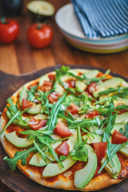 istock Vegan Avocado Pizza with Tomato and Arugula 1176364328