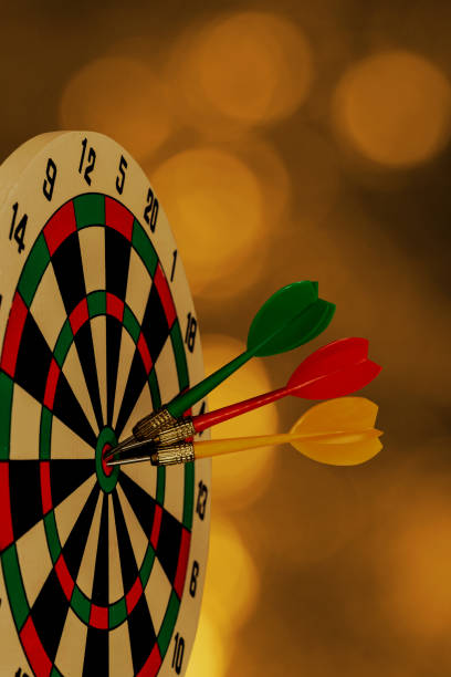 istock Dart arrow hitting in bullseye on dartboard 1176365780
