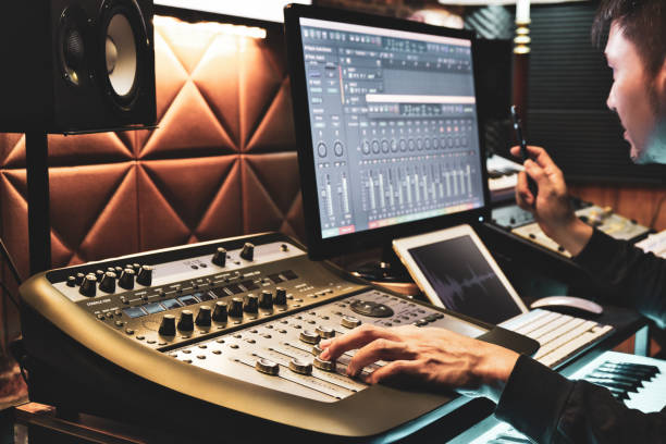 asian male producer working on digital recording equipment in sound studio. music production, broadcasting concept - human finger sound mixer music producer imagens e fotografias de stock