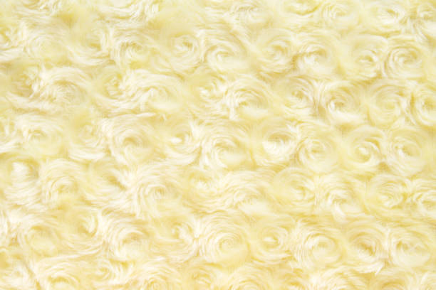 istock texture and background of yellow artificial fur with round curls. 1176366773