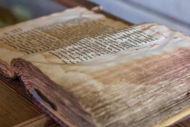 istock Old yellow manuscript on the table. Aged antique book sheets. Stained history document, yellow pages. 1176367015