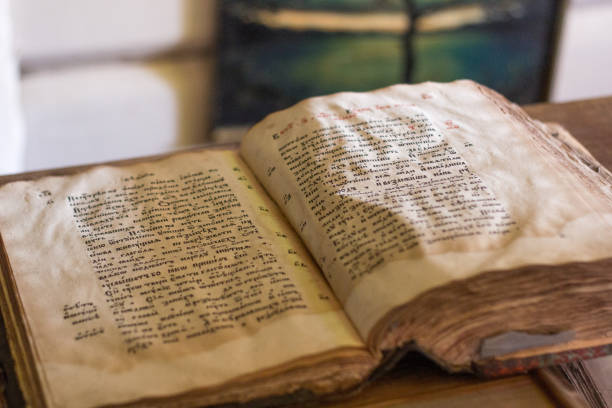 istock Old yellow manuscript on the table. Aged antique book sheets. Stained history document, yellow pages. 1176367106